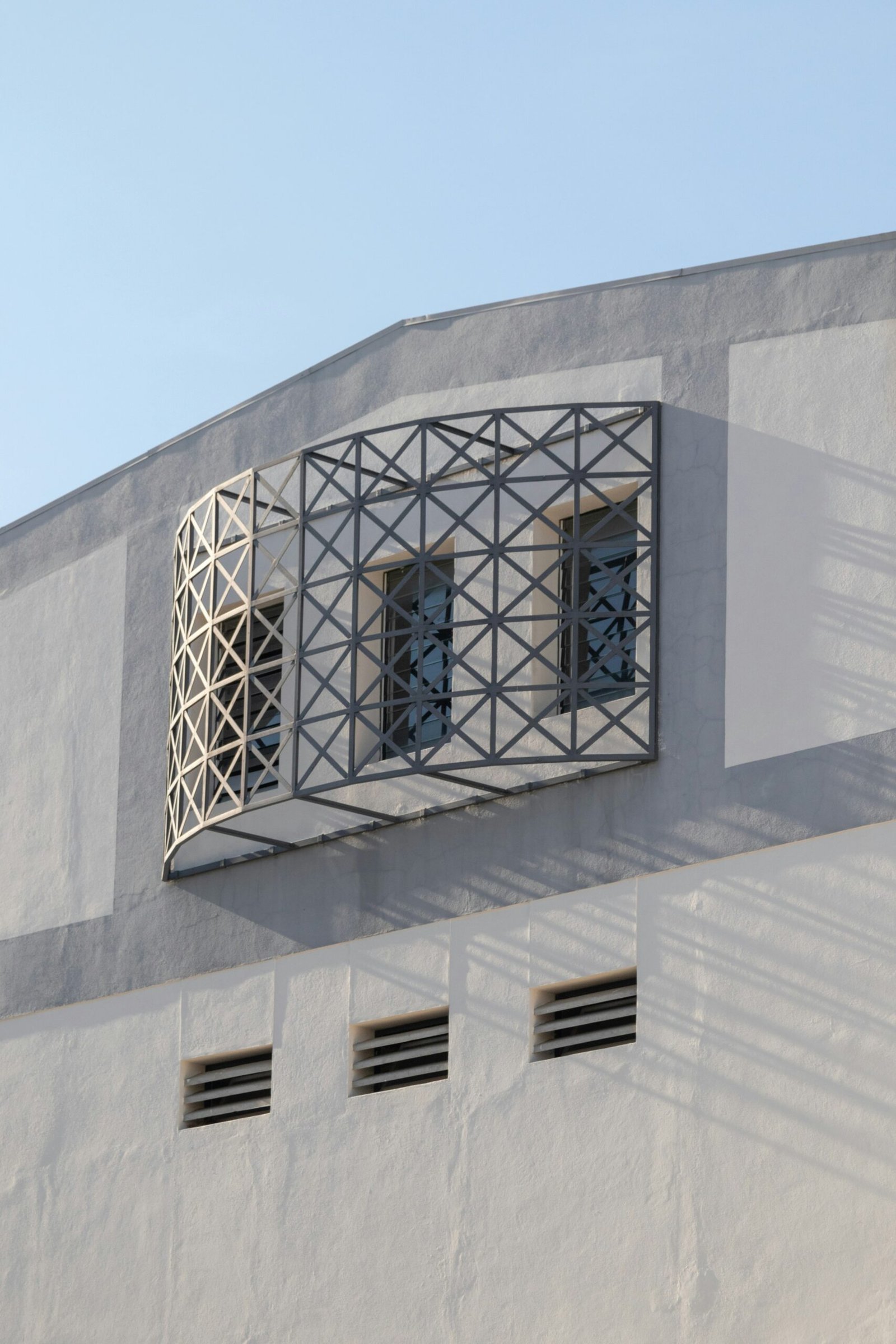 A white building with a window and shutters