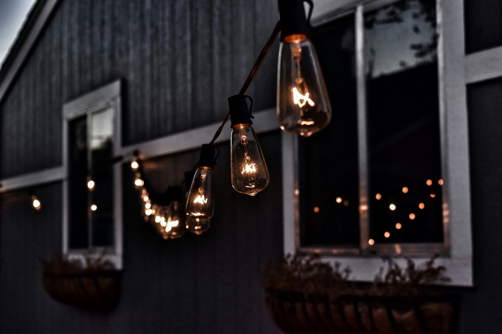 Elevate Your Home's Curb Appeal: Best Outdoor Lighting Ideas for Luxury Exteriors 1 piled hanging lighted bulb beside house